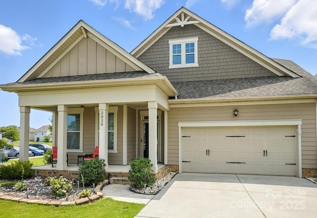 2026 Union Grove Ln, Indian Trail, NC 28079 - craftsman-style house featuring covered porch, concrete driveway, a shingled roof, board and batten siding, and an attached garage