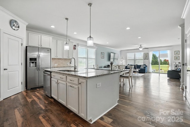 2026 Union Grove Ln, Indian Trail, NC 28079 - kitchen with appliances with stainless steel finishes, a ceiling fan, dark wood-style floors, open floor plan, and light stone counters