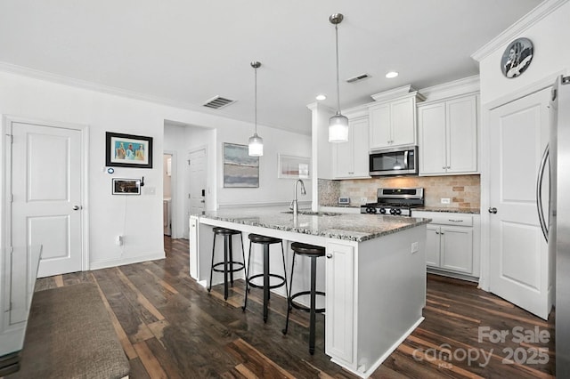 2026 Union Grove Ln, Indian Trail, NC 28079 - kitchen featuring stainless steel appliances, recessed lighting, decorative backsplash, light stone countertops, and ornamental molding