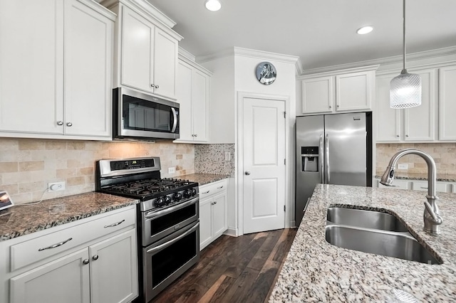 2026 Union Grove Ln, Indian Trail, NC 28079 - kitchen featuring stainless steel appliances, white cabinetry, dark wood finished floors, light stone countertops, and hanging light fixtures