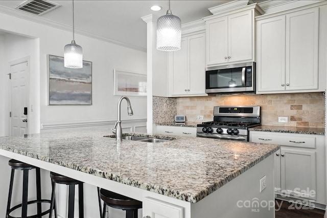 2026 Union Grove Ln, Indian Trail, NC 28079 - kitchen featuring stainless steel appliances, light stone counters, tasteful backsplash, and crown molding