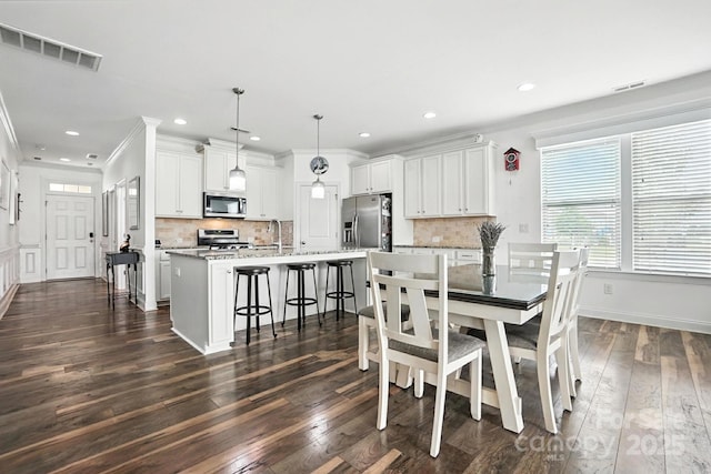 2026 Union Grove Ln, Indian Trail, NC 28079 - dining room with dark wood-type flooring, recessed lighting, and ornamental molding