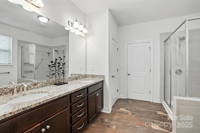 2026 Union Grove Ln, Indian Trail, NC 28079 - bathroom featuring double vanity, wood finished floors, and a shower stall