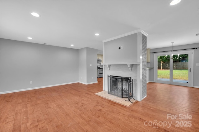 1940 Tyvola Rd, Charlotte, NC 28210 - unfurnished living room with light wood finished floors, a fireplace, and recessed lighting