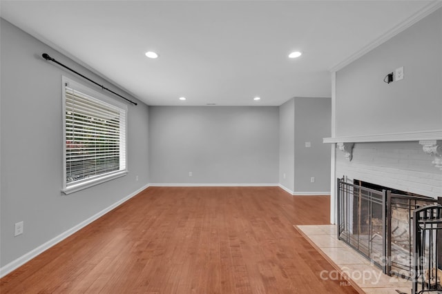 1940 Tyvola Rd, Charlotte, NC 28210 - unfurnished living room with light wood-style flooring, recessed lighting, and a brick fireplace