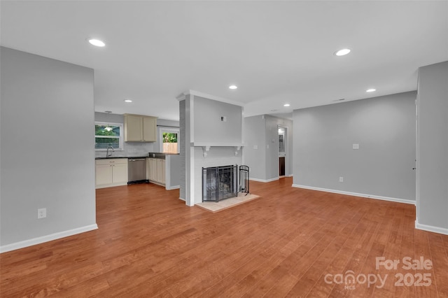 1940 Tyvola Rd, Charlotte, NC 28210 - unfurnished living room with light wood-type flooring, recessed lighting, and a brick fireplace