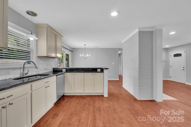1940 Tyvola Rd, Charlotte, NC 28210 - kitchen featuring light wood-type flooring, a chandelier, a peninsula, stainless steel dishwasher, and decorative light fixtures