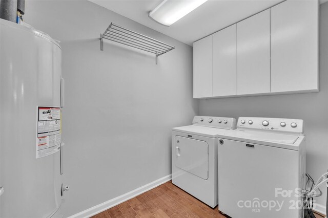 1940 Tyvola Rd, Charlotte, NC 28210 - laundry area with cabinet space, separate washer and dryer, water heater, and light wood-type flooring