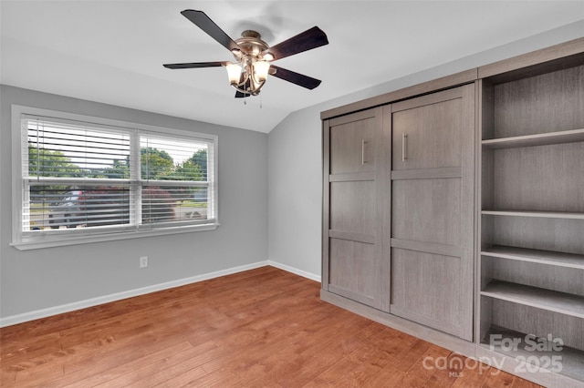 1940 Tyvola Rd, Charlotte, NC 28210 - unfurnished bedroom with light wood-type flooring, vaulted ceiling, and a ceiling fan
