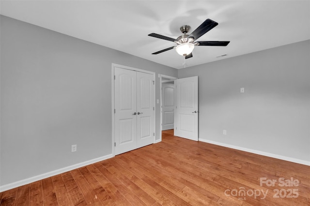 1940 Tyvola Rd, Charlotte, NC 28210 - unfurnished bedroom with light wood-style floors, a closet, and a ceiling fan