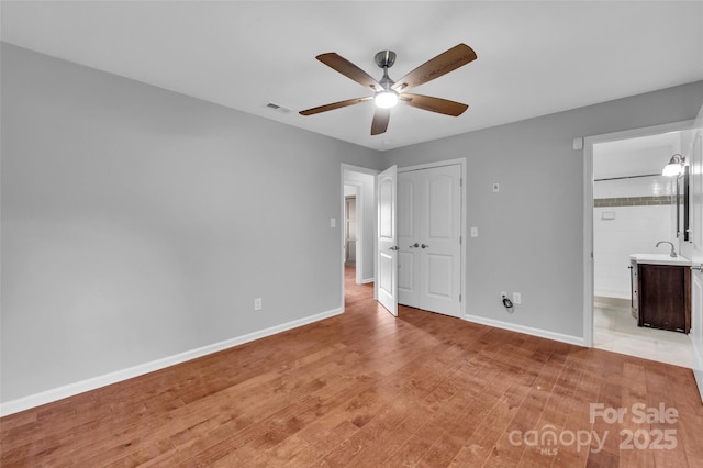 1940 Tyvola Rd, Charlotte, NC 28210 - unfurnished bedroom featuring light wood-type flooring, a closet, a ceiling fan, and ensuite bath
