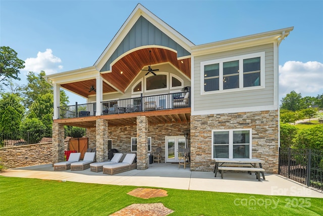 347 Landing Trl, Mount Gilead, NC 27306 - rear view of house featuring a ceiling fan, a balcony, stone siding, and a patio