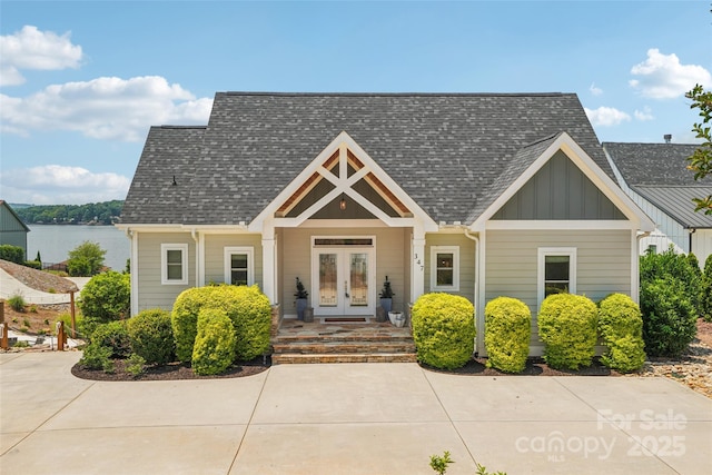 347 Landing Trl, Mount Gilead, NC 27306 - view of front of home with french doors, board and batten siding, and a shingled roof