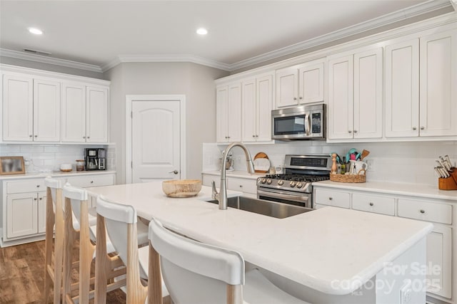 347 Landing Trl, Mount Gilead, NC 27306 - kitchen with appliances with stainless steel finishes, decorative backsplash, a kitchen bar, ornamental molding, and light countertops