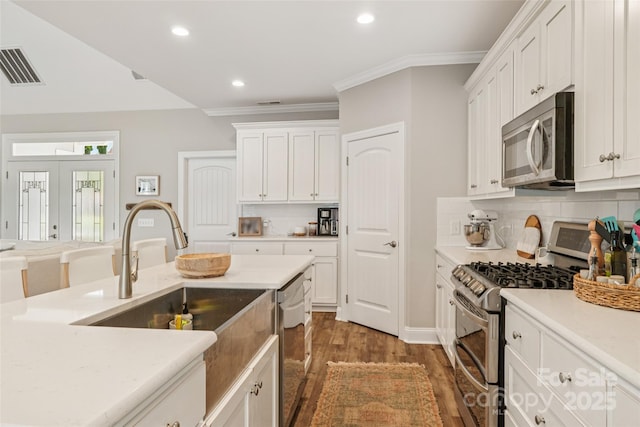 347 Landing Trl, Mount Gilead, NC 27306 - kitchen featuring stainless steel appliances, wood finished floors, white cabinets, decorative backsplash, and recessed lighting