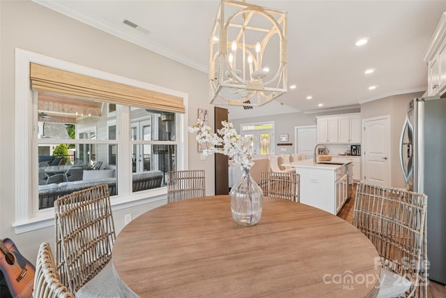 347 Landing Trl, Mount Gilead, NC 27306 - dining space with recessed lighting, a chandelier, crown molding, and dark wood-type flooring