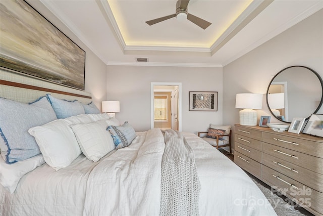 347 Landing Trl, Mount Gilead, NC 27306 - bedroom featuring a tray ceiling, crown molding, ensuite bathroom, and a ceiling fan