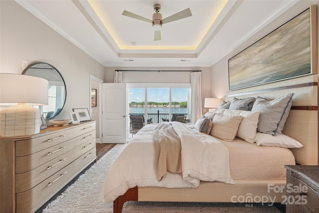 347 Landing Trl, Mount Gilead, NC 27306 - bedroom with access to outside, a tray ceiling, a water view, a ceiling fan, and ornamental molding