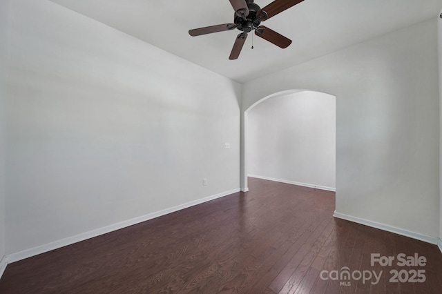 10328 Ebbets Rd, Charlotte, NC 28273 - empty room featuring arched walkways, dark wood-type flooring, and a ceiling fan
