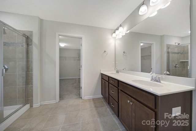 10328 Ebbets Rd, Charlotte, NC 28273 - full bathroom with a walk in closet, double vanity, a stall shower, and tile patterned flooring