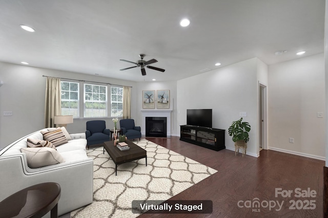 10328 Ebbets Rd, Charlotte, NC 28273 - living area with wood finished floors, recessed lighting, a glass covered fireplace, and ceiling fan