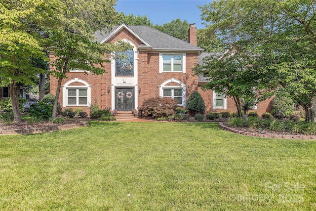 3100 Shady Grove Ln, Matthews, NC 28104 - colonial inspired home featuring a chimney, a front yard, and brick siding