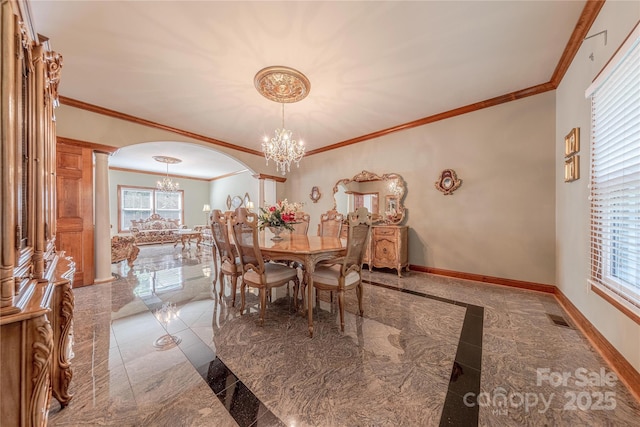 3100 Shady Grove Ln, Matthews, NC 28104 - dining room featuring a chandelier, arched walkways, crown molding, decorative columns, and healthy amount of natural light