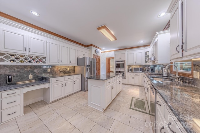3100 Shady Grove Ln, Matthews, NC 28104 - kitchen with stainless steel appliances, decorative backsplash, white cabinetry, a kitchen island, and recessed lighting