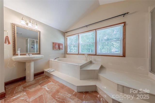 3100 Shady Grove Ln, Matthews, NC 28104 - bathroom featuring a bath, lofted ceiling, and stone finish flooring