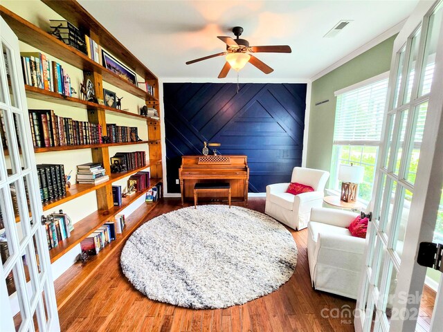 10302 Newbridge Rd, Charlotte, NC 28278 - sitting room featuring a ceiling fan, wood finished floors, and ornamental molding