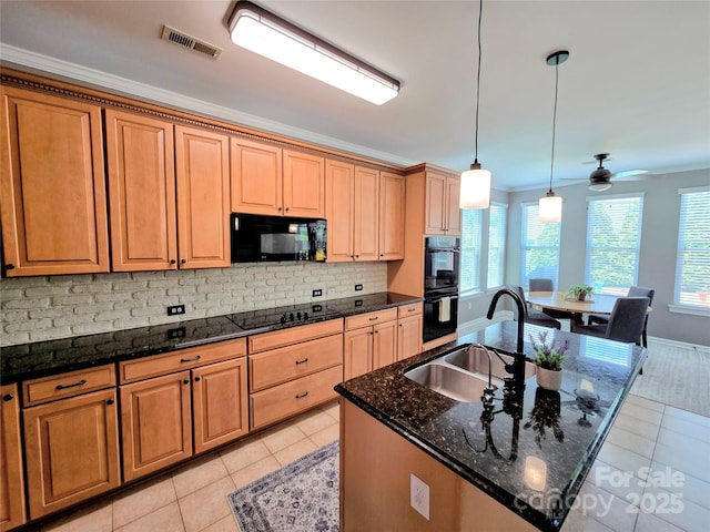 10302 Newbridge Rd, Charlotte, NC 28278 - kitchen with black appliances, light tile patterned flooring, tasteful backsplash, dark stone counters, and an island with sink