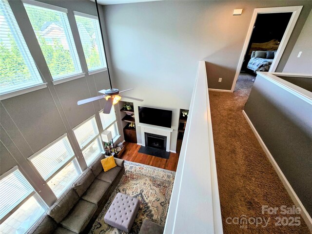 10302 Newbridge Rd, Charlotte, NC 28278 - living room featuring ceiling fan, a fireplace with flush hearth, and carpet flooring