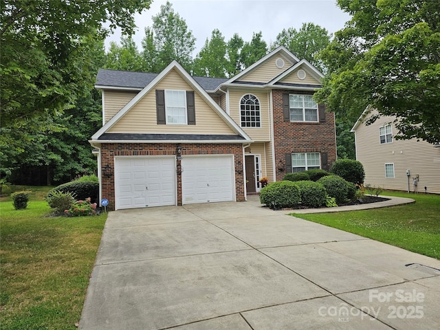 935 Wind Carved Ln, Monroe, NC 28110 - traditional home with concrete driveway, a front yard, brick siding, and an attached garage