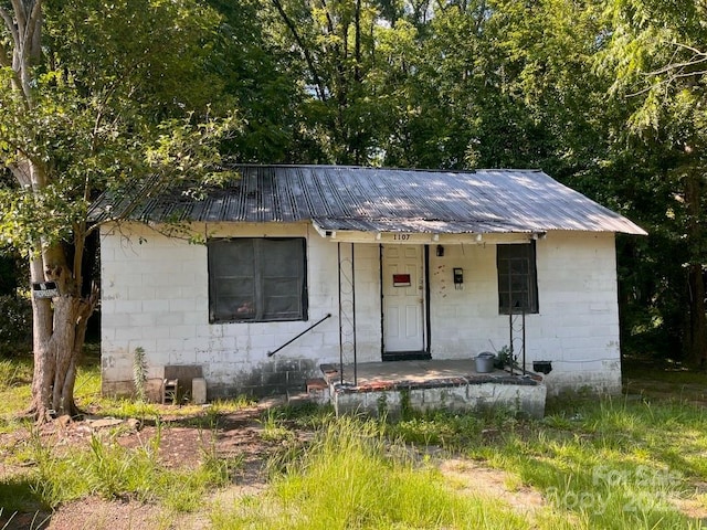 1107 Armstead St, Rockingham, NC 28379 - view of front of home with concrete block siding and a metal roof