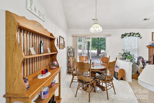 11100 Scrimshaw Ln, Charlotte, NC 28215 - dining area featuring a chandelier and lofted ceiling