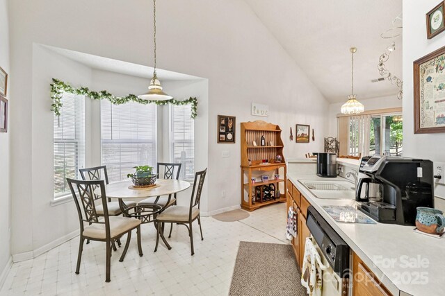 11100 Scrimshaw Ln, Charlotte, NC 28215 - dining room featuring high vaulted ceiling, a chandelier, and light flooring