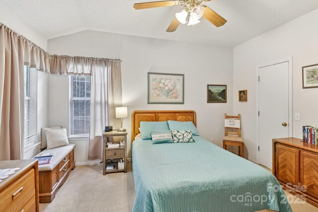 11100 Scrimshaw Ln, Charlotte, NC 28215 - bedroom featuring light colored carpet, lofted ceiling, and ceiling fan