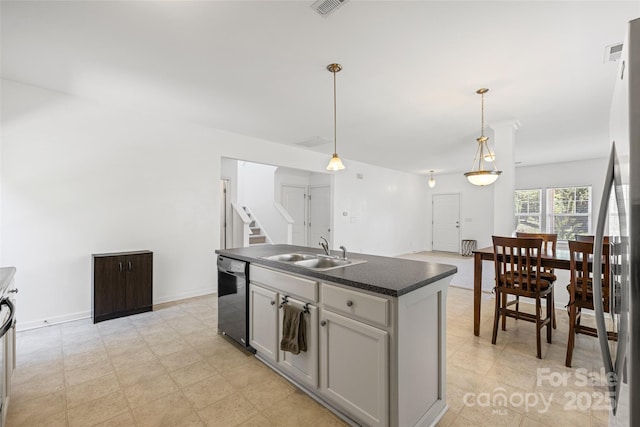 1287 Century Dr, Clover, SC 29710 - kitchen featuring dishwashing machine, dark countertops, pendant lighting, an island with sink, and stainless steel refrigerator