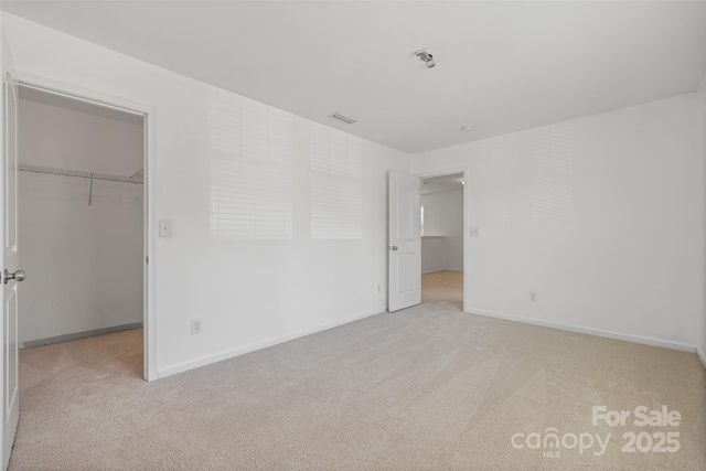 1287 Century Dr, Clover, SC 29710 - unfurnished bedroom featuring carpet, a walk in closet, and a closet