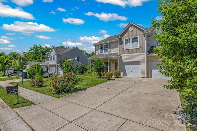 1287 Century Dr, Clover, SC 29710 - traditional home with board and batten siding, driveway, a garage, and a front lawn