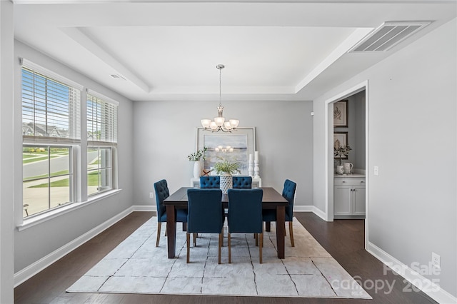 2225 Masons Bend Dr, Fort Mill, SC 29708 - dining room with a tray ceiling, a chandelier, and wood finished floors