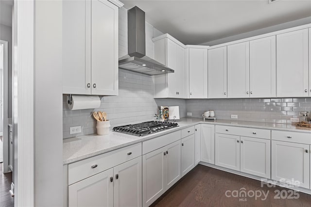 2225 Masons Bend Dr, Fort Mill, SC 29708 - kitchen featuring wall chimney range hood, stainless steel gas stovetop, dark wood-style floors, white cabinets, and backsplash
