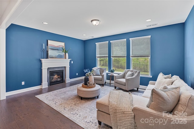 2225 Masons Bend Dr, Fort Mill, SC 29708 - living area featuring wood finished floors, a glass covered fireplace, and recessed lighting