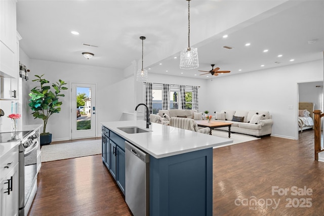 305 Redberry Ct, York, SC 29745 - kitchen with stainless steel appliances, blue cabinetry, ceiling fan, open floor plan, and white cabinetry