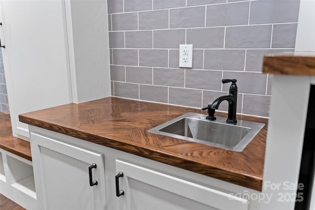 305 Redberry Ct, York, SC 29745 - kitchen featuring decorative backsplash and white cabinetry