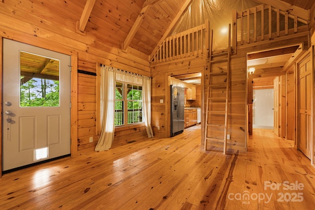 41 Waya Way, Whittier, NC 28789 - foyer entrance with light wood-style floors, wooden walls, beamed ceiling, and high vaulted ceiling