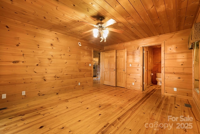 41 Waya Way, Whittier, NC 28789 - unfurnished bedroom featuring wood walls, wooden ceiling, light wood-style flooring, and ensuite bathroom