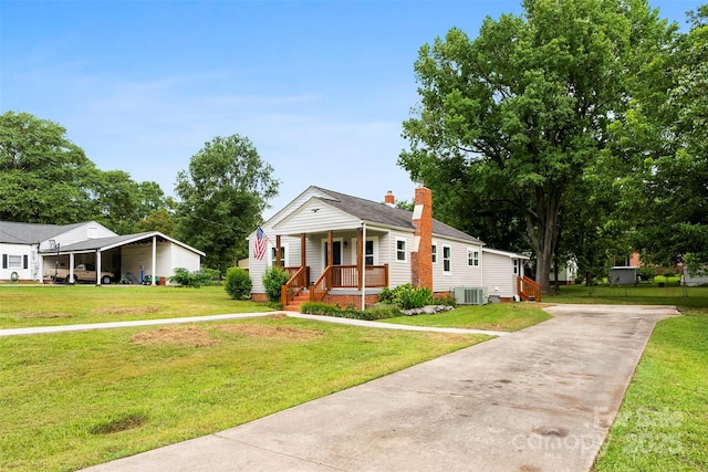 410 Gann St, Lowell, NC 28098 - view of front of property with concrete driveway, a porch, a front yard, and a chimney