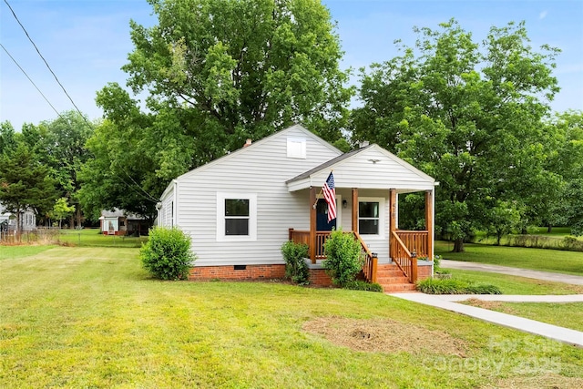410 Gann St, Lowell, NC 28098 - bungalow featuring crawl space, a front lawn, and covered porch