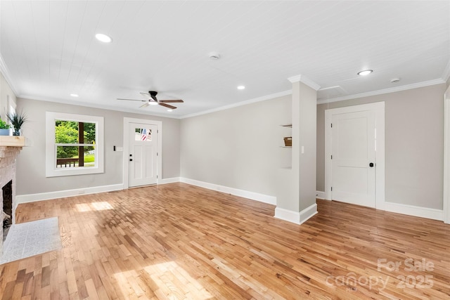 410 Gann St, Lowell, NC 28098 - unfurnished living room featuring light wood-style flooring, a brick fireplace, a ceiling fan, recessed lighting, and ornamental molding